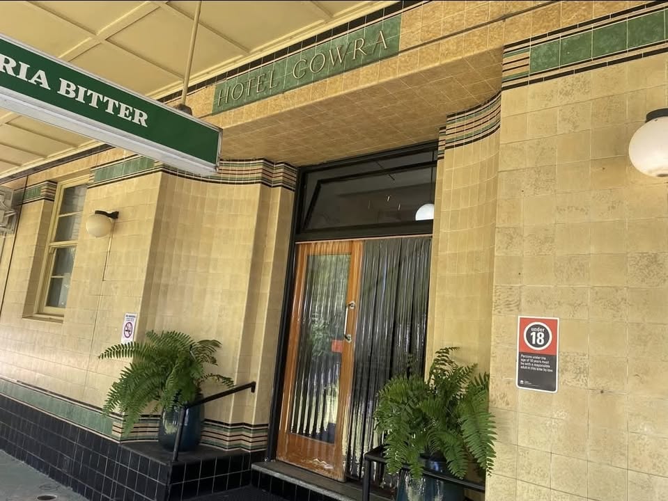 The tiled Hotel Cowra entrance with ferns either side of the door